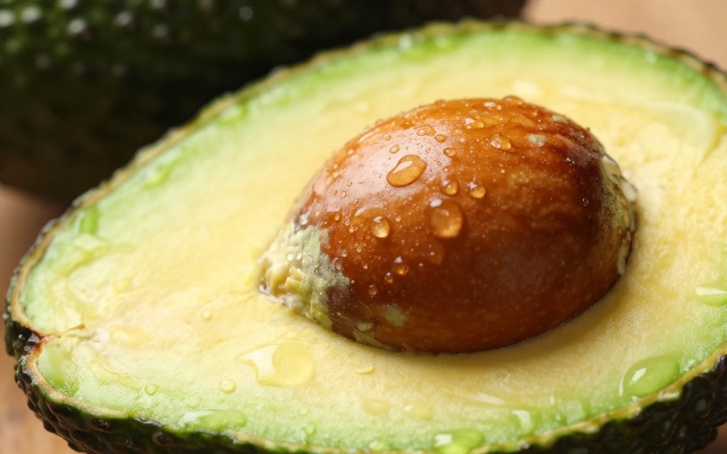 Macro view of a halved avocado showing the creamy flesh where most avocado calories come from fat
