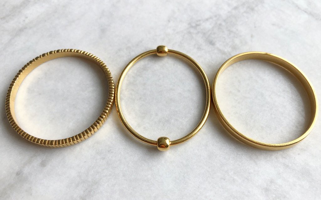 Comparison of 14k, 18k and 24k gold jewelry showing value per gram by karat