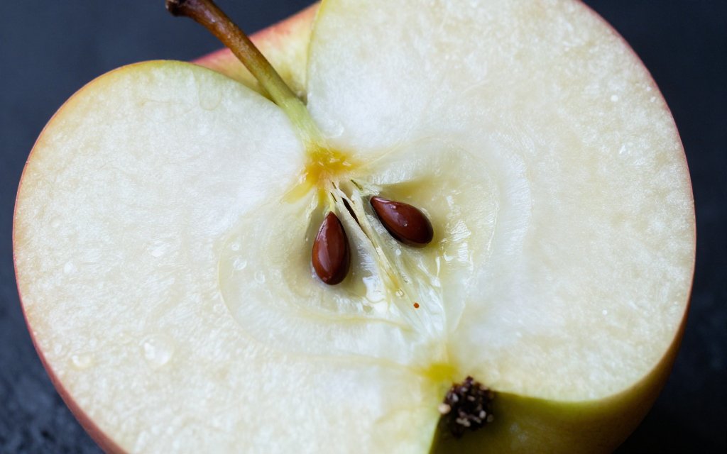 Macro view of a cut apple showing the skin and flesh where the fiber and calories in an apple sit