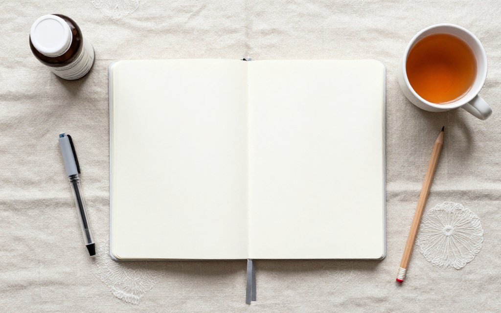 Flat lay of a planner, injection pen and prenatal vitamins, the kind of setup used when planning around tirzepatide and pregnancy